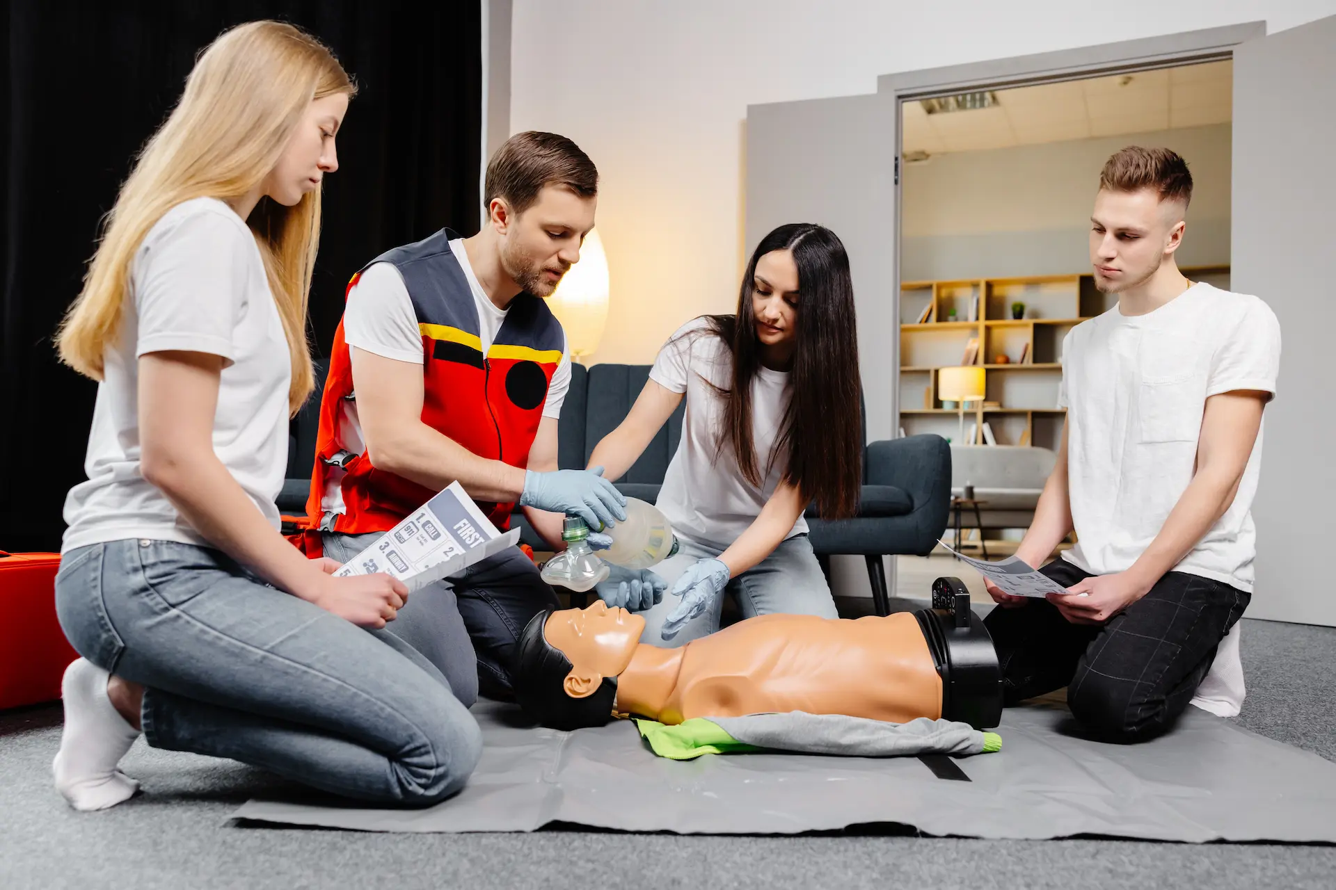 Group people learning how make first aid heart compressions with dummies training indoors